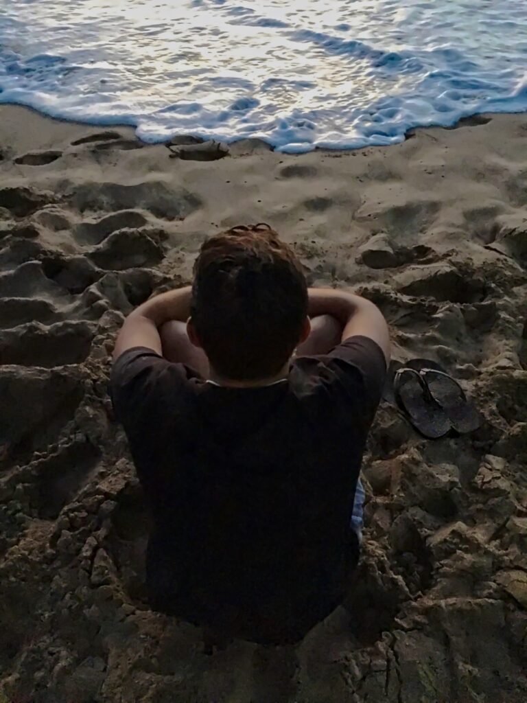 guy with depression on beach