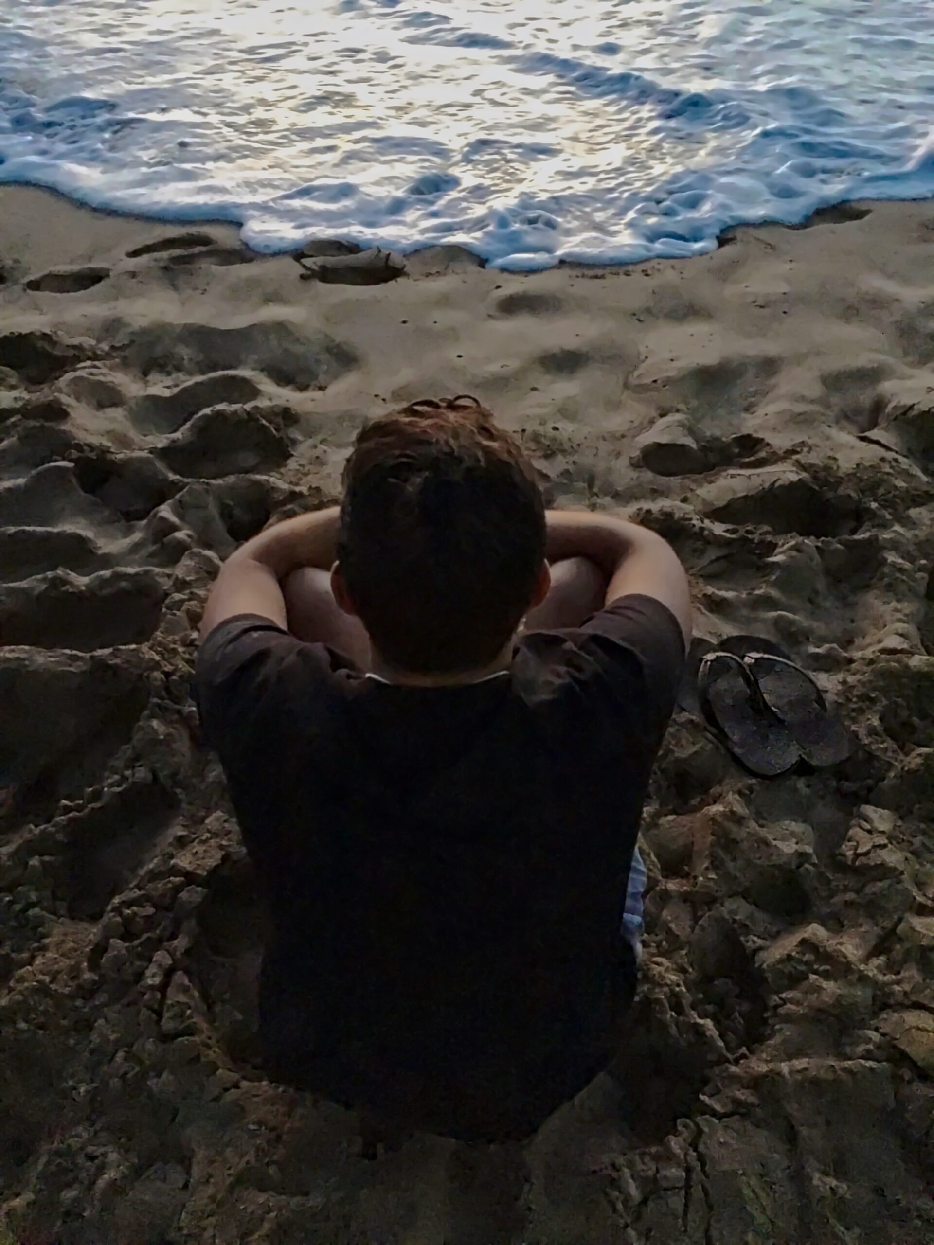guy with depression on beach