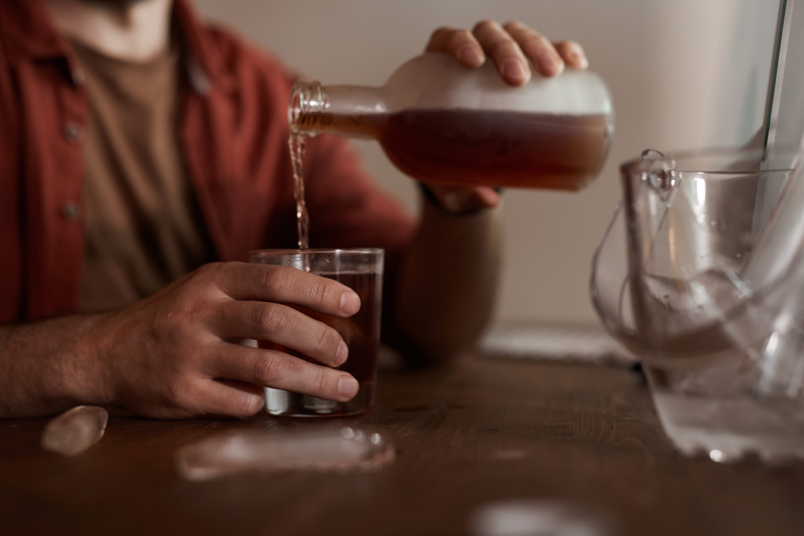 man pouring drink of alcohol high functioning alcoholic