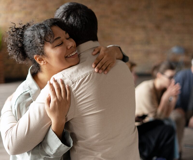 two friends hugging  healthy relationships in recovery​