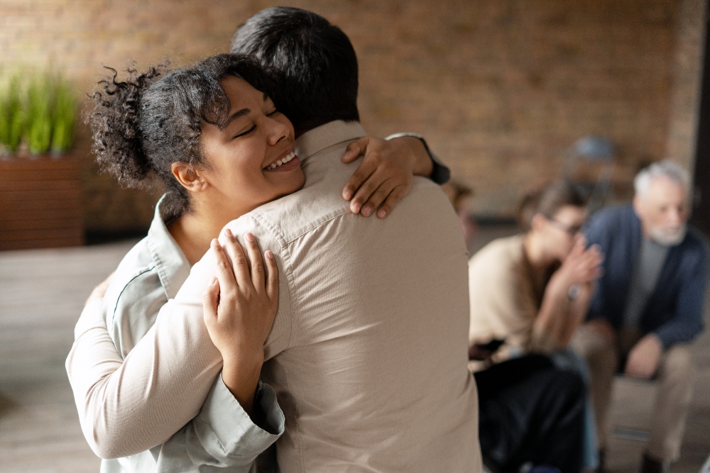 two friends hugging healthy relationships in recovery