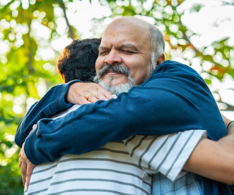 man hugging son struggling with drug abuse  signs of prescription drug abuse​