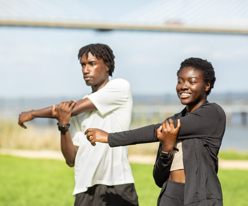 young adults stretching at a park  how can i create a healthy routine in addiction recovery