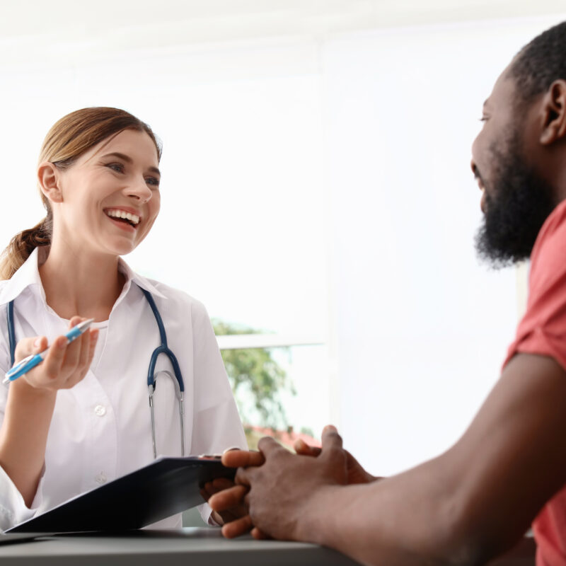 A doctor and a patient smiling together talking about how long is iop.