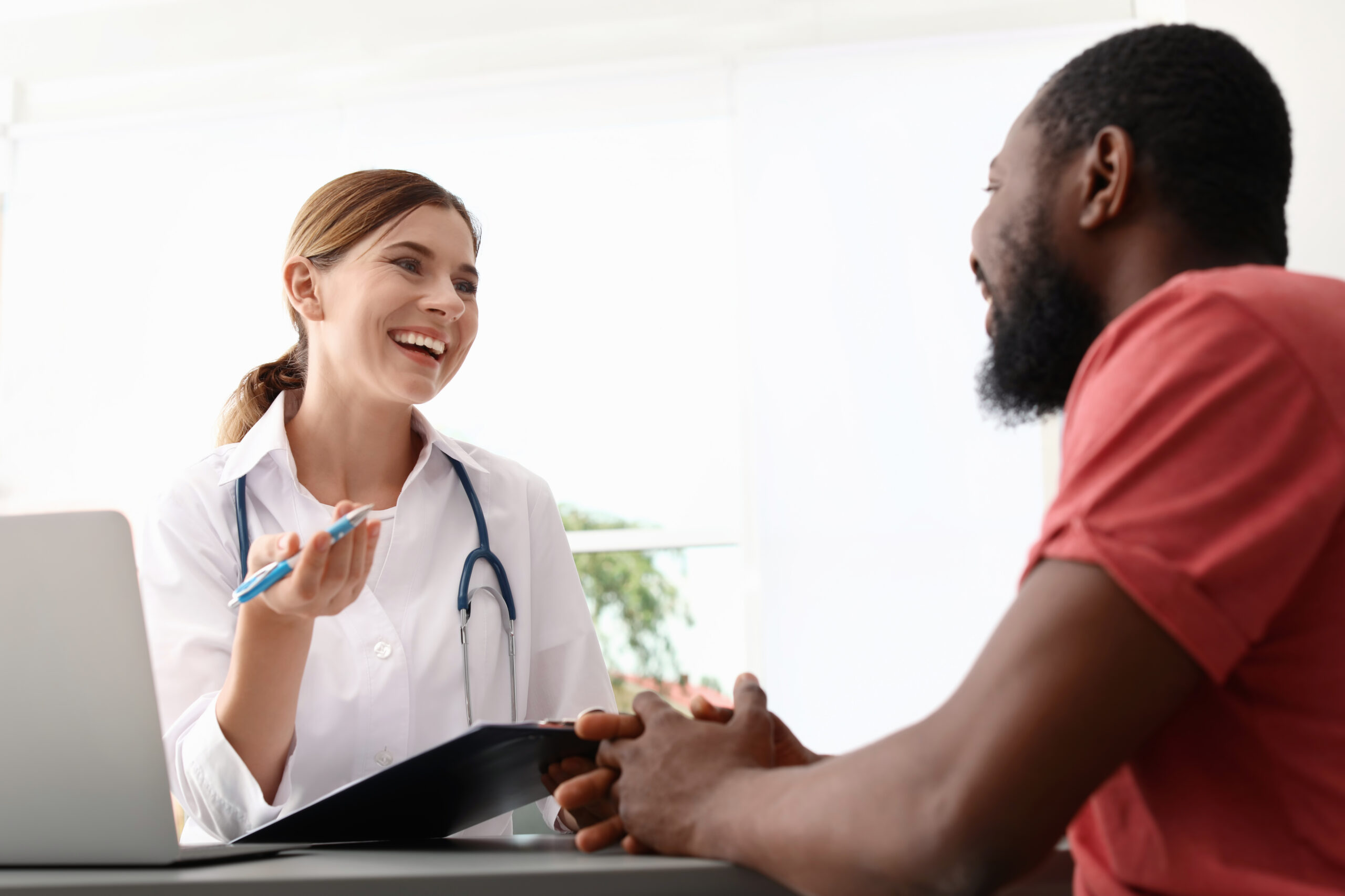 A doctor and a patient smiling together talking about how long is iop.